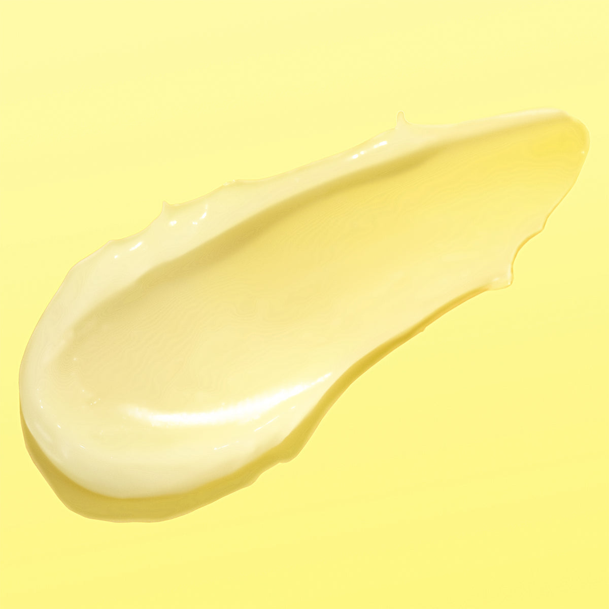 A glossy swatch of blended Vitamin-C CremeSerum yellow cream or lotion on a solid light yellow background.