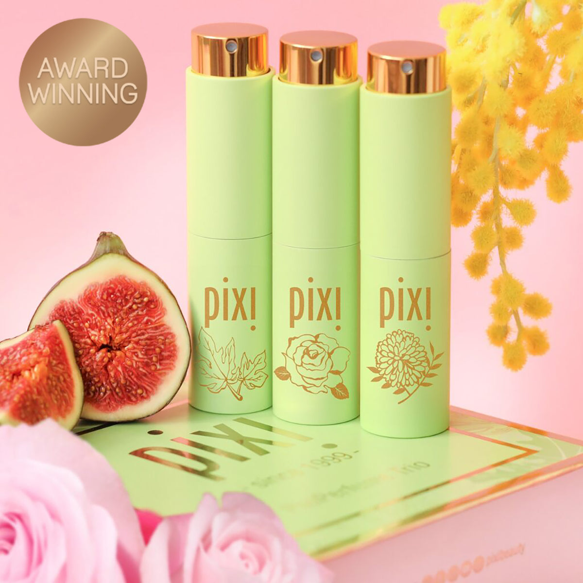 Award Winning: PixiPerfume Gift Trio shown on a pink background with plants